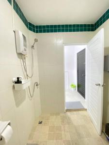 a bathroom with a shower and a toilet and a sink at Shaka Guest House in Kata Beach