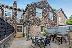 a brick house with a table and chairs in front of it at The Harrogate Townhouse in Harrogate