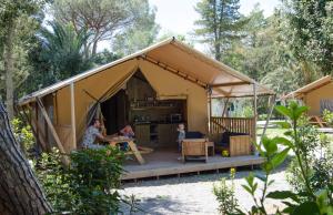 a group of people sitting in a tent at Camping Campo dei Fiori - Glamping4all in Vada