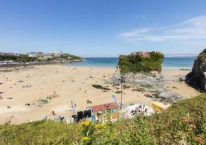 a beach with a bunch of people on it at Hyper-central Newquay, sleeps 3 in Newquay