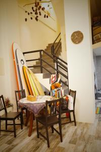 a dining room with a table and surfboards on the wall at 鰆宿民宿 in Dayin