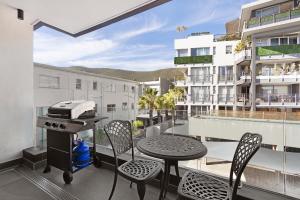 a balcony with a grill and a table and chairs at Casa on Quendon by Totalstay in Cape Town