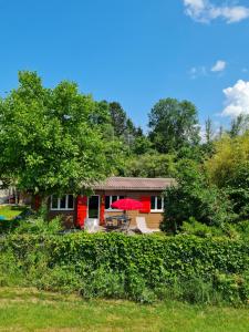 a house with a tree and a patio at Rhône Cottage 4 in Noville