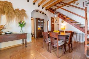 a dining room with a wooden table and chairs at Alconasser in Sóller