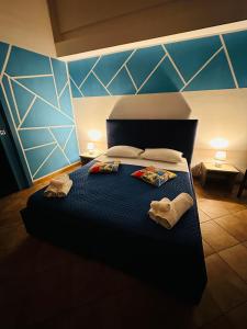 a bedroom with a bed with two towels on it at Cartari Apartment in Palermo