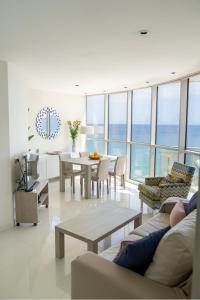 a living room with a couch and a table and chairs at Apartamentos Vista Bella in Calpe
