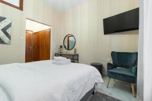 Ένα ή περισσότερα κρεβάτια σε δωμάτιο στο Παραδοσιακός Ξενώνας Βαμβακούς