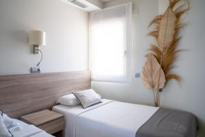 a bedroom with a bed and a window at Apartamentos Vista Bella in Calpe +169 photos