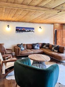 a living room with a couch and a table at La Ferme du Nant - Portes du Soleil in La Chapelle-dʼAbondance +56 photos
