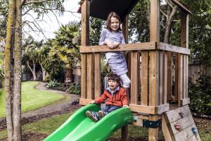 a boy and girl playing on a playground at JetPark Auckland Airport Hotel in Auckland