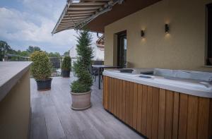 a large bath tub on a patio with potted plants at ATANA Luxury Apartments in Si&oacute;fok
