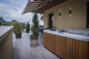 a large bath tub on a patio with potted plants at ATANA Luxury Apartments in Siófok