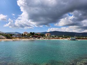a body of water with a beach in the background at Airport Split in Kastel Stafilic