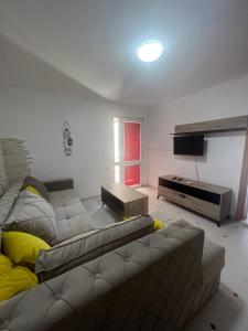 a living room with a couch and a television at Villa Ajša in Bar