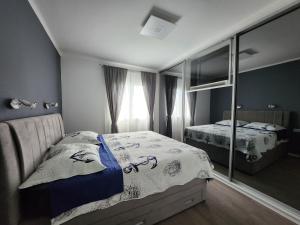 a bedroom with a bed and a mirror at Airport Split in Kastel Stafilic