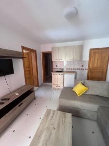 a living room with a couch and a yellow pillow at Villa Ajša in Bar