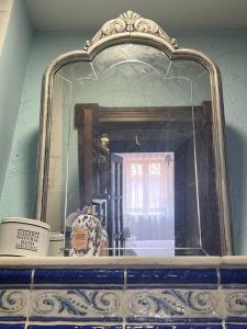 a mirror on top of a shelf in a room at Casa Rural La Ferrería in Vinuesa