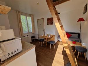 a living room with a kitchen and a dining room at Tiny house avec jardin spacieux in Saint-Nazaire