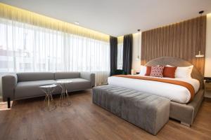 Voodi või voodid majutusasutuse Le M Hôtel toas
