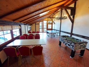 a room with two ping pong tables and chairs at Zajazd PTTK Pod Roztoką in Rytro