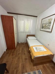 Postel nebo postele na pokoji v ubytování Apartmani Tina