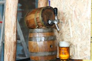 a wooden wine barrel and a mug of beer at Mpora River Lodge in Rundu