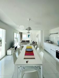 - un salon blanc avec une table et des chaises blanches dans l'établissement Can Sabatilla, à Cadaqués