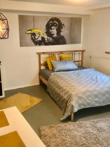1 dormitorio con 1 cama y una pintura en la pared en Gartenapartment Souterrain für Hundefreunde, en Friesen