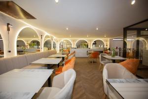 a restaurant with tables and chairs and a bar at Le M Hôtel in Rabat