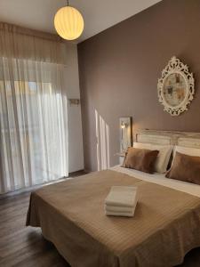 a bedroom with a large bed with a large window at Hotel Villa Esedra in Bellaria-Igea Marina