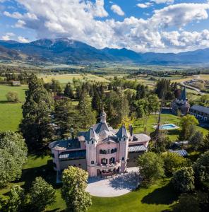 an aerial view of a mansion with mountains in the background at Torre del Remei in Bolvir