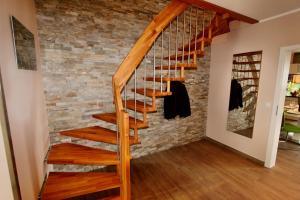 a staircase in a home with a brick wall at Ferien_HAUS LIMERICK in Göhren-Lebbin