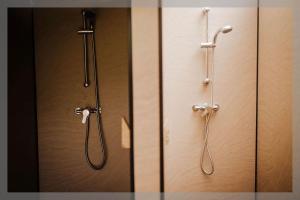 a bathroom with a shower and a shower head at Ty Llewelyn Glamping & Camping in Llanidloes