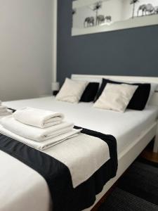 two beds with towels sitting on top of them at Apartments Loncar-near Zrće beach in Novalja
