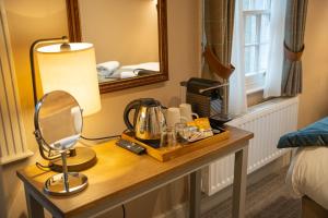 a hotel room with a table with a mirror at Duke of York in Whitby