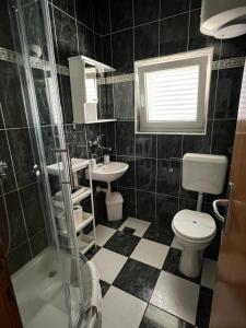a bathroom with a toilet and a sink and a shower at Apartments Loncar-near Zrće beach in Novalja