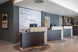 a lobby with a large wall with a large screen at Premier Inn Freiburg City Süd in Freiburg im Breisgau