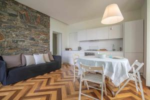a living room with a table and a couch at Villa Vescovo Appartamento con accesso al lago in Orta San Giulio