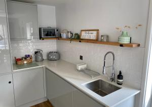 a kitchen with a sink and a counter top at ‘The Loft’ - Apartment by the sea in Combe Martin