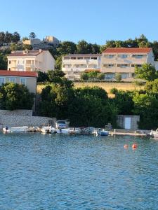 a group of boats are docked in the water at Apartments Loncar-near Zrće beach in Novalja