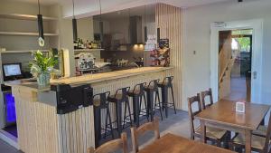 a restaurant with a bar with chairs and a table at Aran Hostel in Salardú