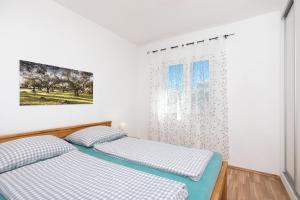 Posteľ alebo postele v izbe v ubytovaní Apartments Oleander
