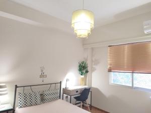 A bed or beds in a room at Vacations in Patra Rooms