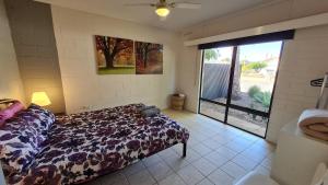 a bedroom with a bed and a large sliding glass door at Stay Awhile in Port Pirie - min stay 4 nights in Port Pirie