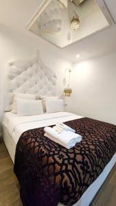 a bedroom with a large bed with two towels on it at Villa das Arábias Boutique Hotel in Maputo