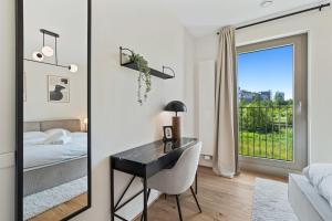 a bedroom with a desk and a bed and a mirror at Gem in Historic District Belval in Sanem