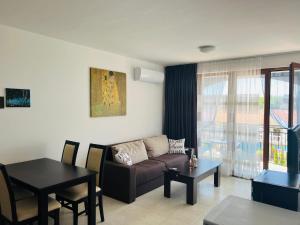 a living room with a couch and a table at Apartment Marina beach k-s Triumph in Sveti Vlas