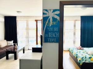 a living room with a sign that says youre on beach time at Apartment Marina beach k-s Triumph in Sveti Vlas