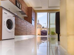 a laundry room with a washer and dryer at Casa Deguara townhouse Rabat Malta in Rabat