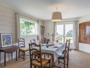 a dining room with a table and chairs and a window at Holiday Home La Belle Vue - LOQ209 by Interhome in Locquirec